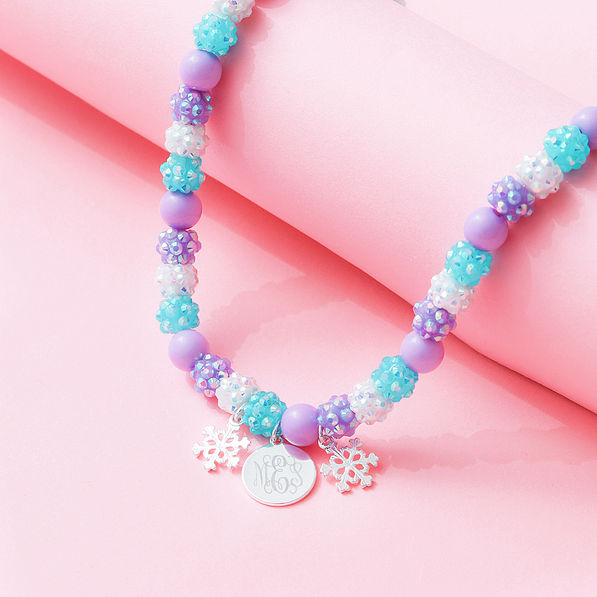 girls snowflake necklace on pink background