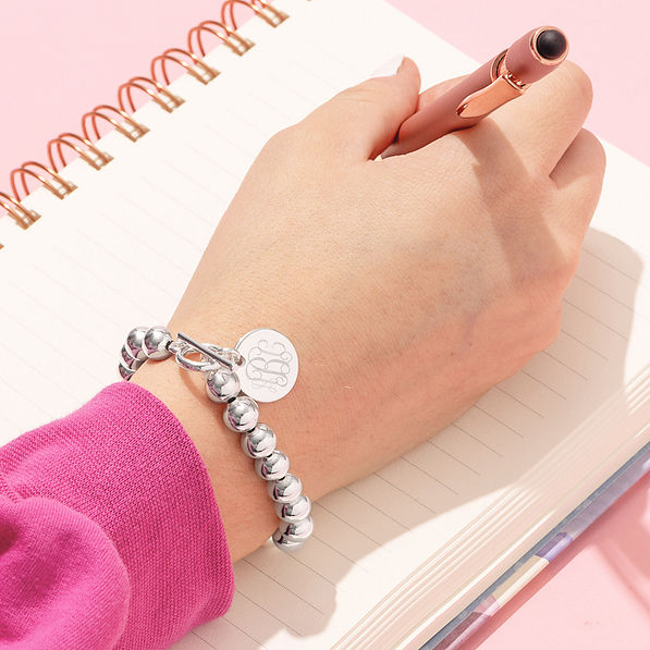 silver monogrammed kids ball bracelet on wrist