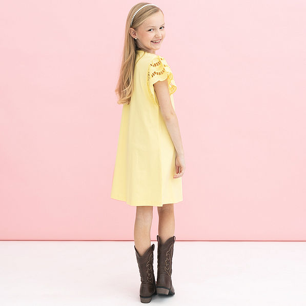 back of girl wearing soft yellow personalized girls flutter sleeve dress