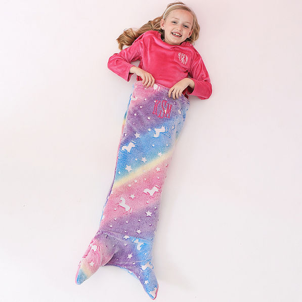 girl wearing rainbow unicorn monogrammed mermaid blanket