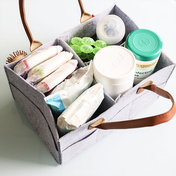 gray diaper caddy with diapers inside