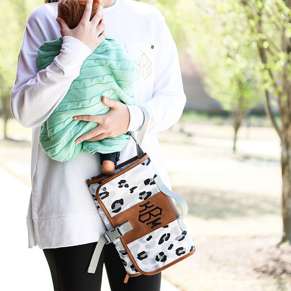 black sassy spots baby changing pad with baby on shoulder