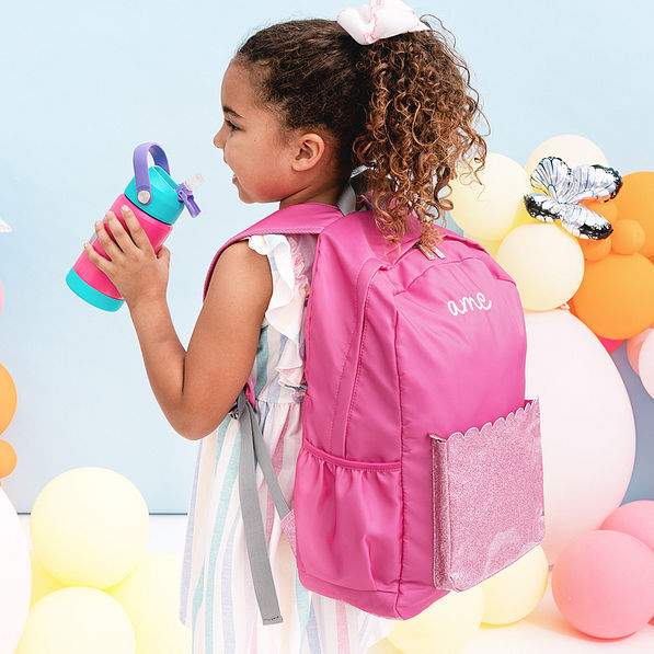 girl drinking from monogrammed hot pink and mint flip straw water bottle