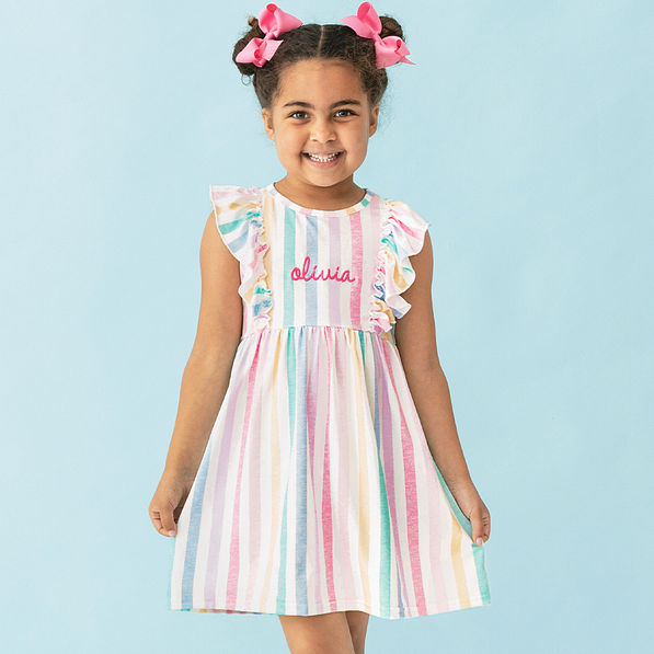 girl wearing monogrammed girls multi striped ruffle knit dress up close