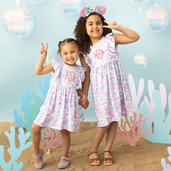 mermaid ruffle dresses on two girls sea background