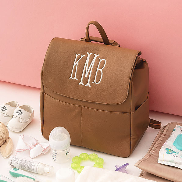 monogrammed diaper backpack purse with girls toys and accessories