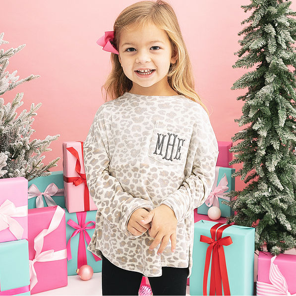 girl wearing monogrammed kids snow leopard pullover
