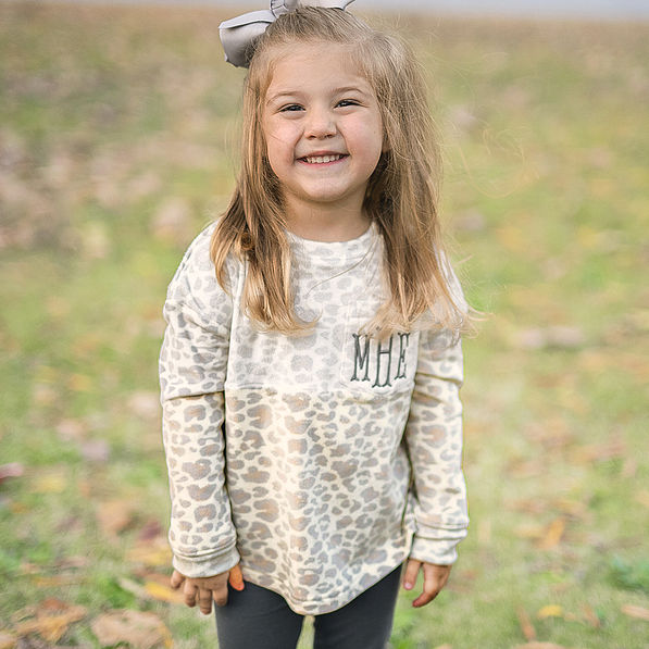 girl wearing monogrammed snow leopard softspun pullover sweatshirt