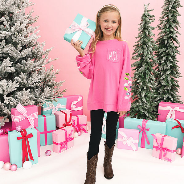 christmas sweatshirt in hotpink on girl holding a present