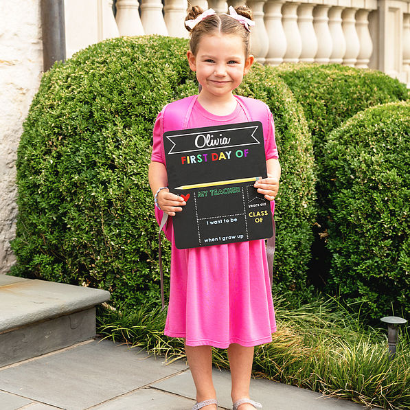elle holding back to school chalkboard