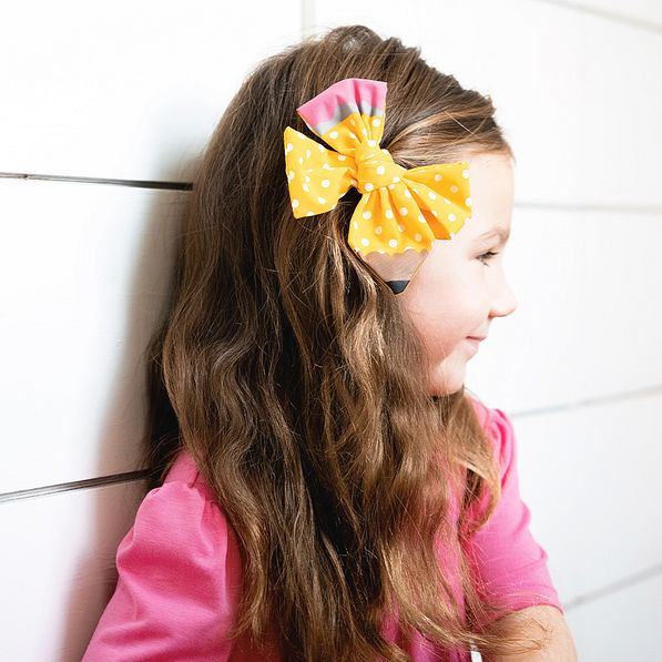 yellow girls pencil hair bow set with hair clipped to the side
