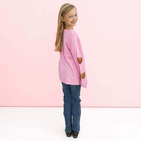 back of girl wearing kids sequin hearts sweatshirt