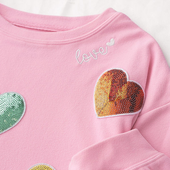 close up of kids sequin heart sweatshirt