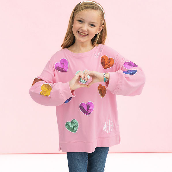 girl wearing kids monogrammed light pink sequin hearts sweatshirt