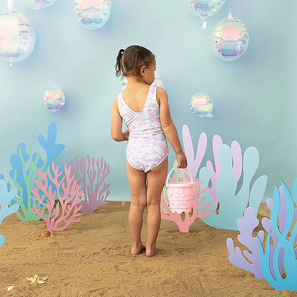 Back of Girl wearing ruffle bathing suit in mermaid