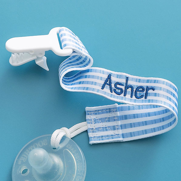 close up of personalized paci clip in navy seersucker