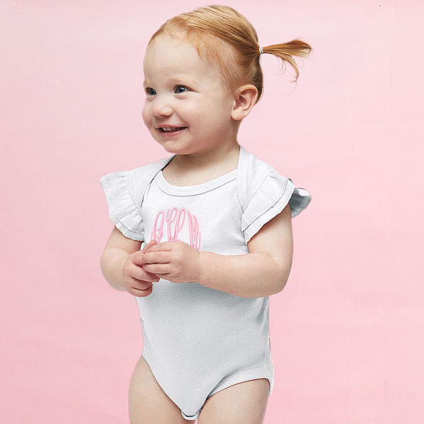 girl wearing monogrammed flutter sleeve bodysuit in white with pink monogram