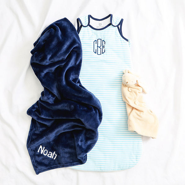 navy blue baby blanket flatlay with baby wearable blanket