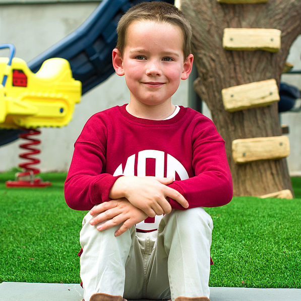 sitting on playground with youth crewneck sweatshirt
