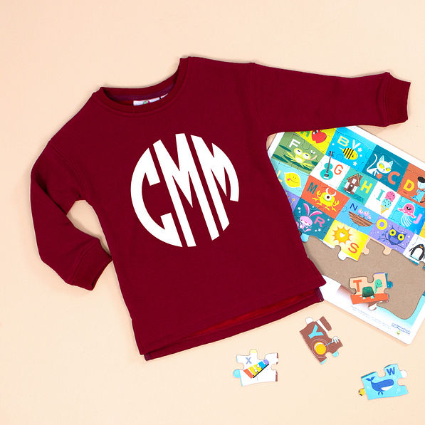 crimson pullover with puzzle pieces