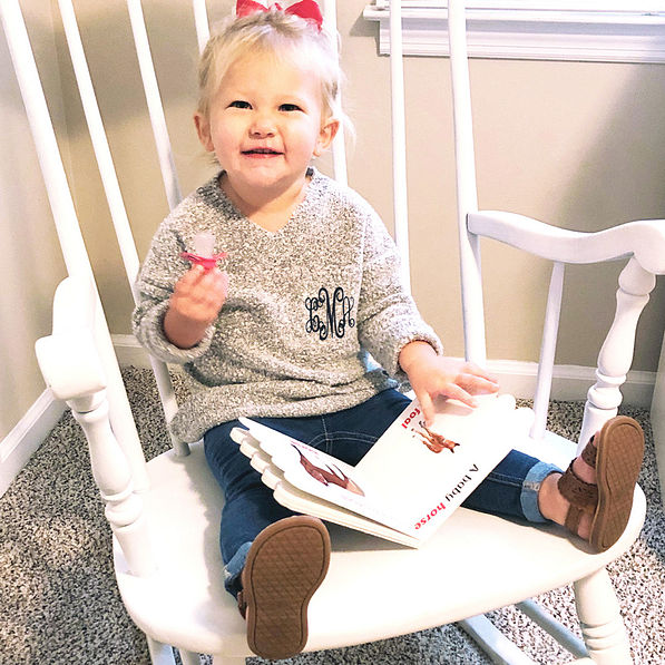 little girl in gray monogrammed sweater