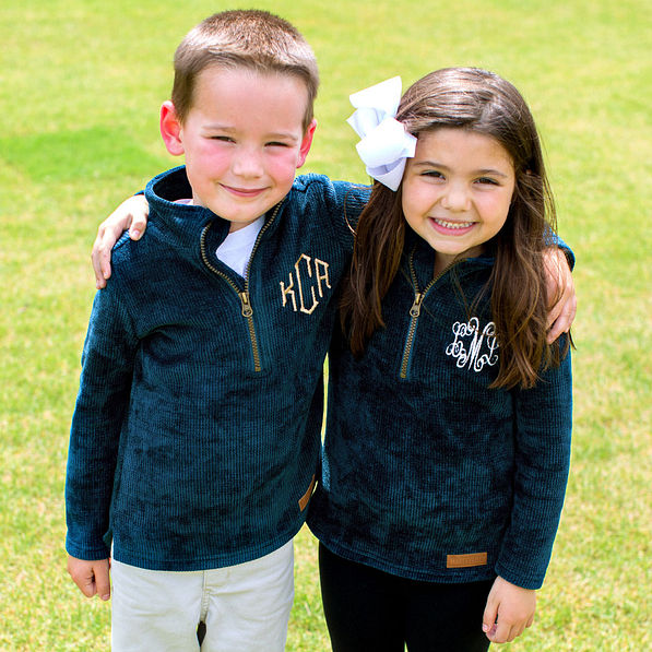 friends wearing matching teal corded pullovers