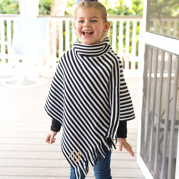youth girl wearing black and white fringe poncho
