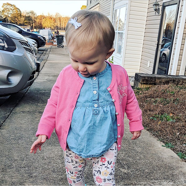 baby girl wearing pink cardigan