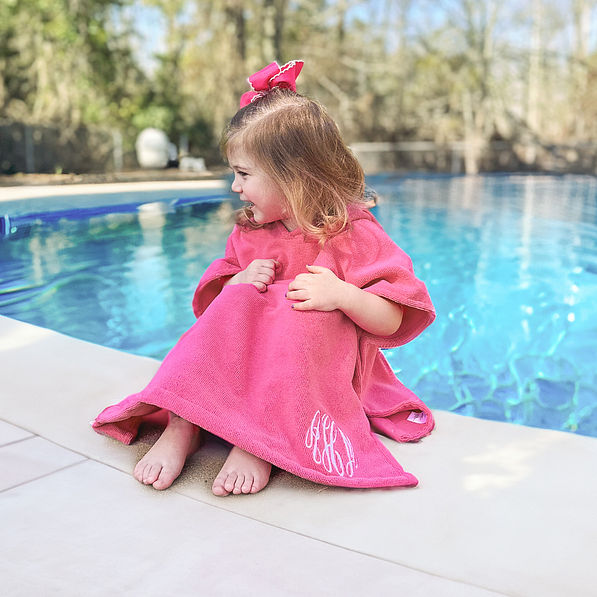 girl wearing hot pink toddler hooded swim poncho cover up
