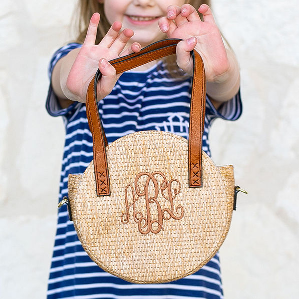 close up of girls round straw crossbody bag