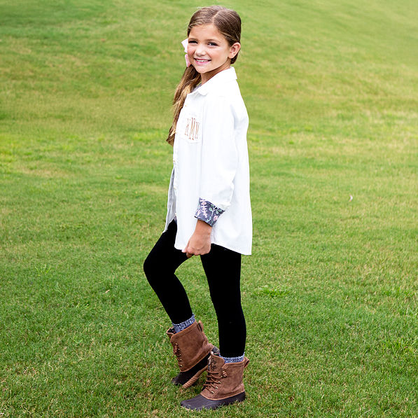 side shot of girl wearing white button down tunic