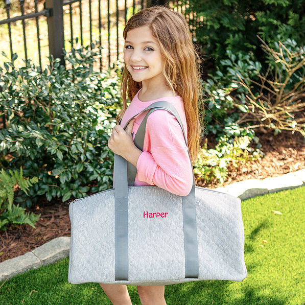 girls gray duffel bag on shoulder with name monogram