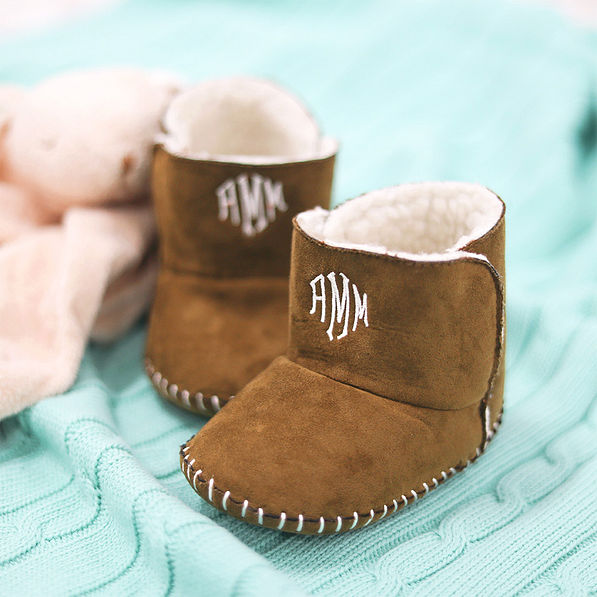 brown baby booties on blanket