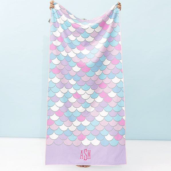 girl holding monogrammed kids beach towel in mint mermaid