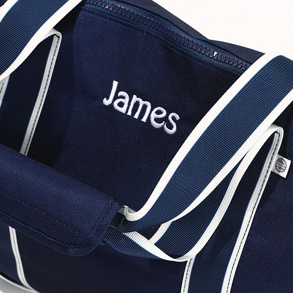 close up of navy boys embroidered weekend duffle bag