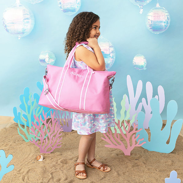bubblegum pink kids weekend bag on shoulder