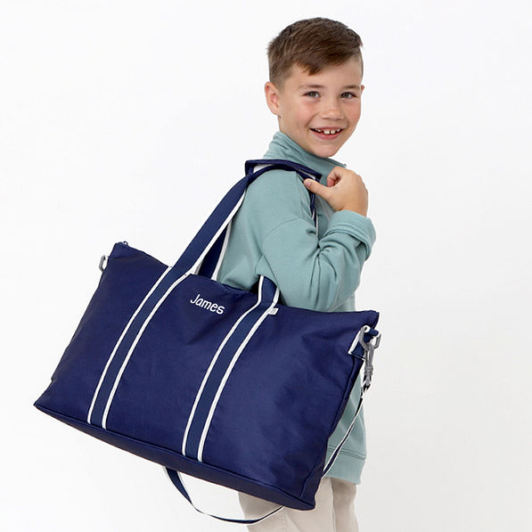 boy with navy kids weekend bag over shoulder casual block