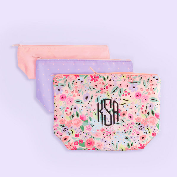 monogrammed kids toiletry bag in coral floral purple background