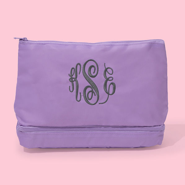 monogrammed kids toiletry bag in lilac pink background