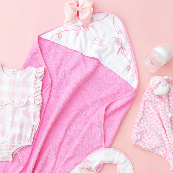 pink bows baby hooded bath towel on pink background