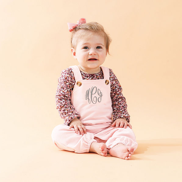 blush monogrammed overalls on baby