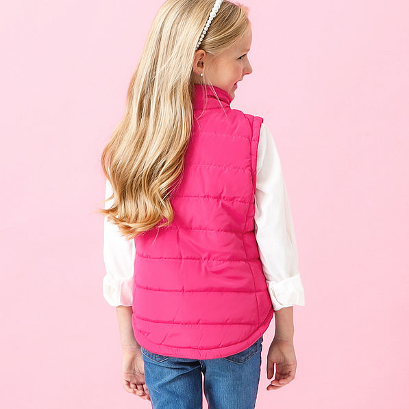 pink kids puffer vest on addie - back view