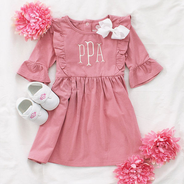 baby shoes with pink monogram flatlay