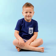 boy sitting wearing monogrammed navy outfit