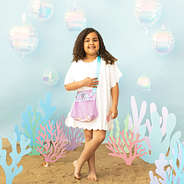 girl with mermaid monogrammed seashell bag sea background