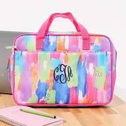 multi paintbrush laptop bag sitting on desk