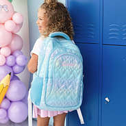 blue quilted hearts backpack worn by girl
