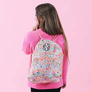 girl wearing coral floral cinch bag