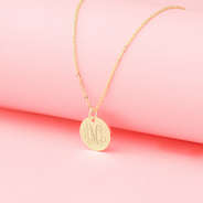 gold kids disc necklace with pink background 2024