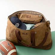 inside of waxed canvas weekender with dopp kit and wallet